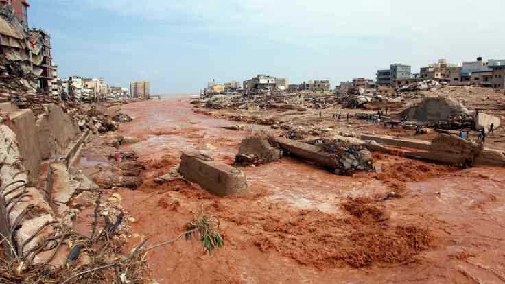 People look at the damage caused by freak floods in Derna, eastern Libya, on September 11, 2023.